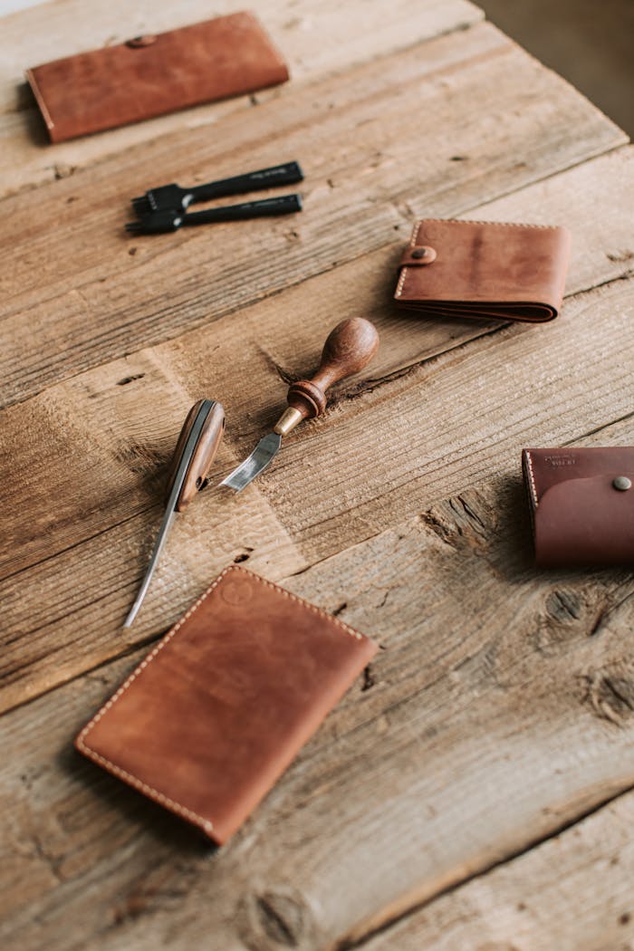 Crafting Captivating Headlines: Your awesome post title goes here Artisanal leather wallets with crafting tools on a rustic wooden table, showcasing craftsmanship.